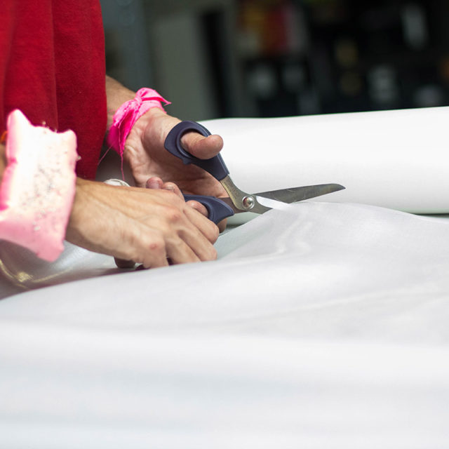 Image of woman's hands cutting fabric
