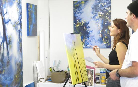 Image of an artist painting in her studio