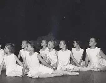 Young girls sitting as part of a ballet performance
